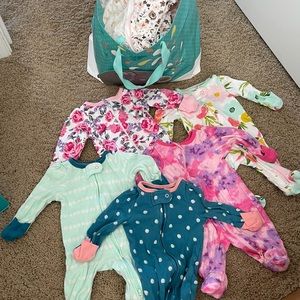 A bunch of new born onesies with the foots.
